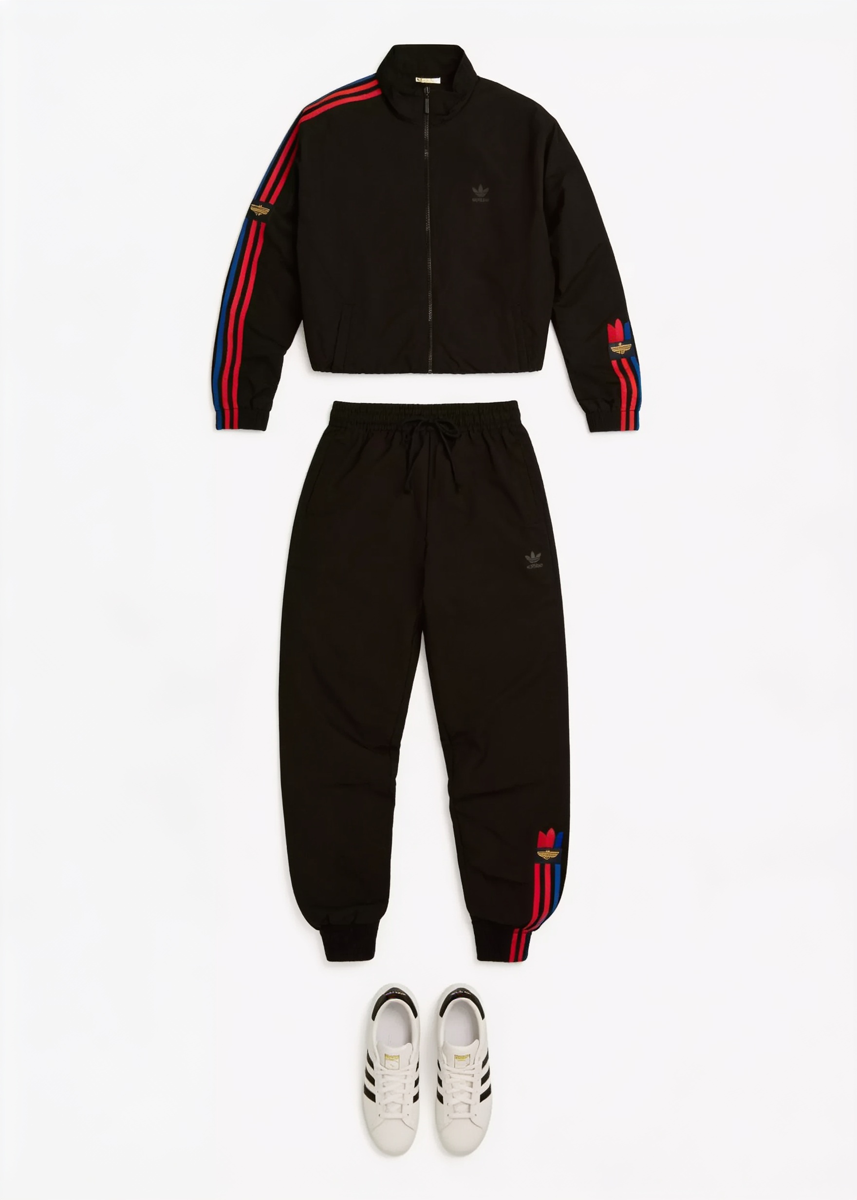 Black tracksuit and white striped sneakers